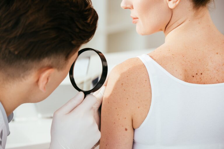 dermatologist inspecting skin